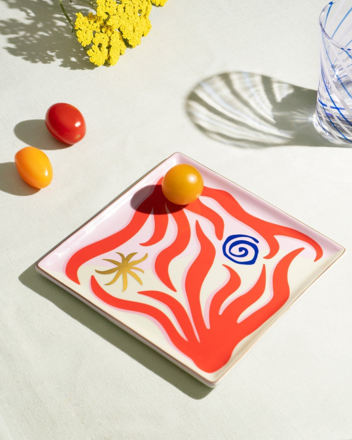 The Octaevo Amalfi Ceramic Tray features Mediterranean coral motifs and holds a yellow tomato—an ideal, stylish gift.