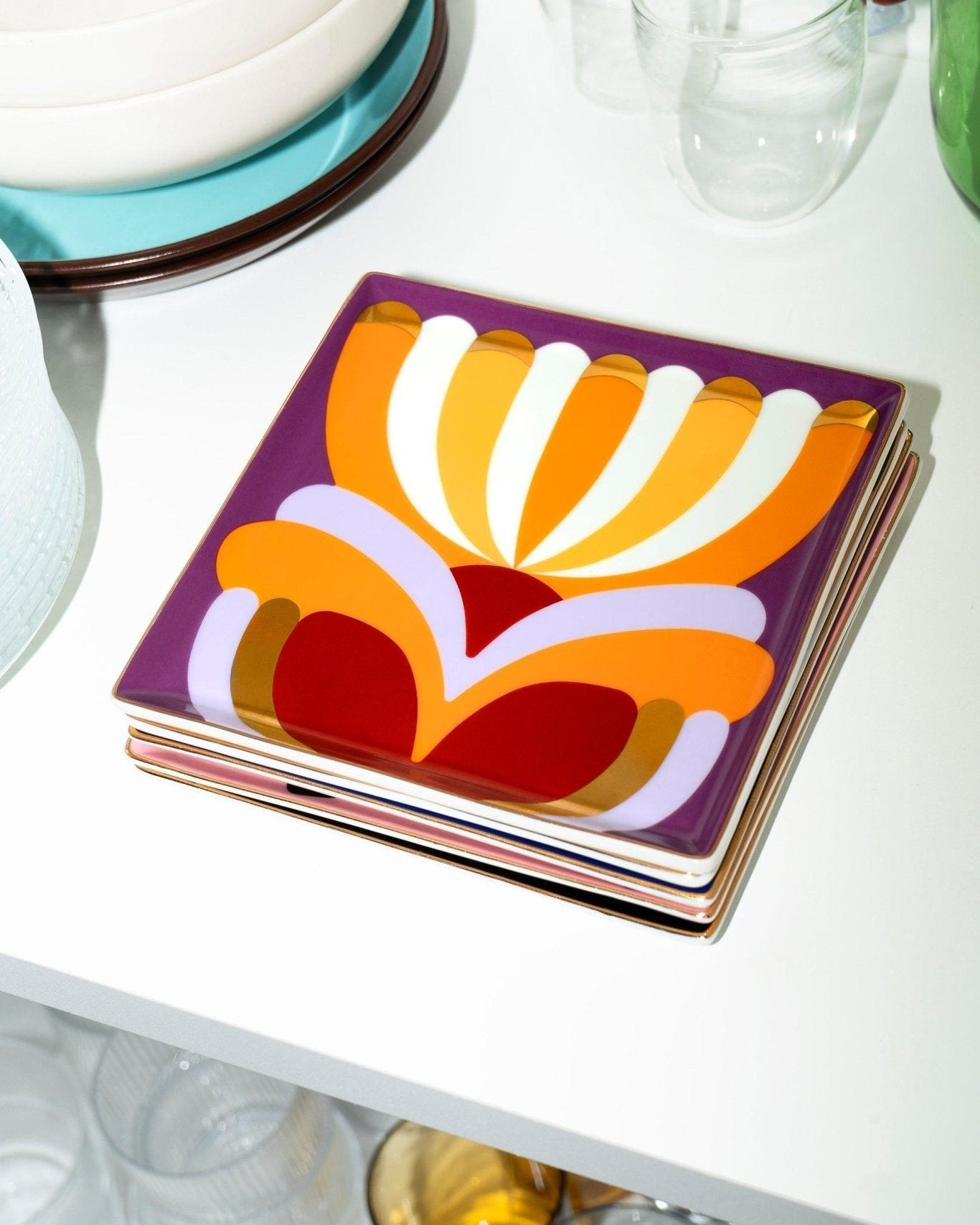 Octaevo Elysia Ceramic Tray with bold, abstract patterns displayed on a white shelf among glassware.