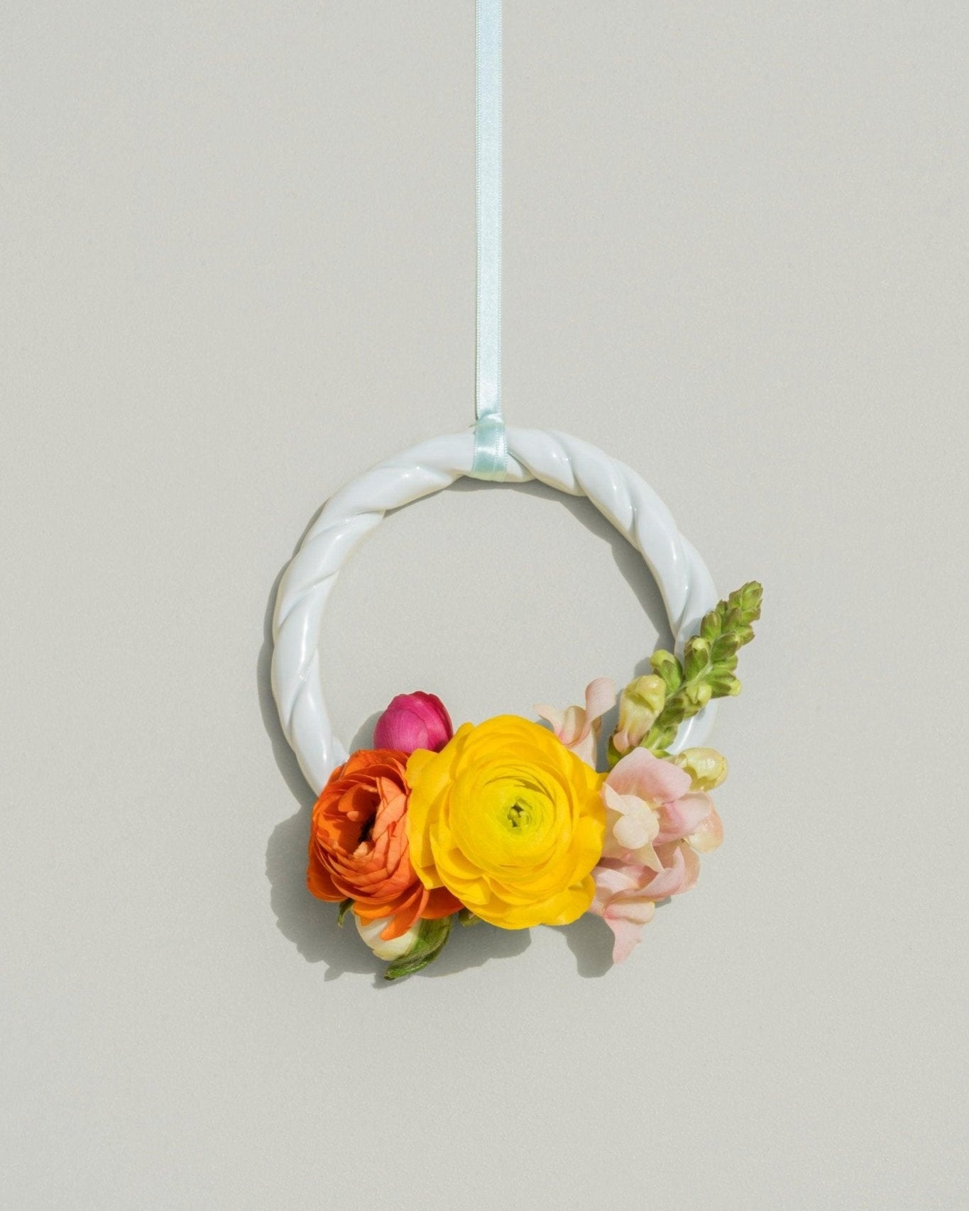 The light mint Sicilia Ceramic Trivet by OCTAEVO features vibrant flowers and a ribbon—perfect decor for table or wall.