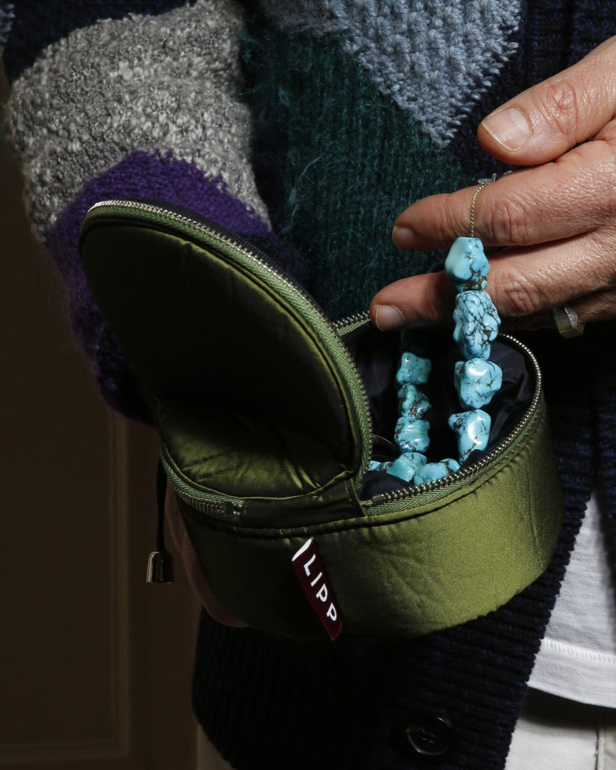 Person holding a green case 