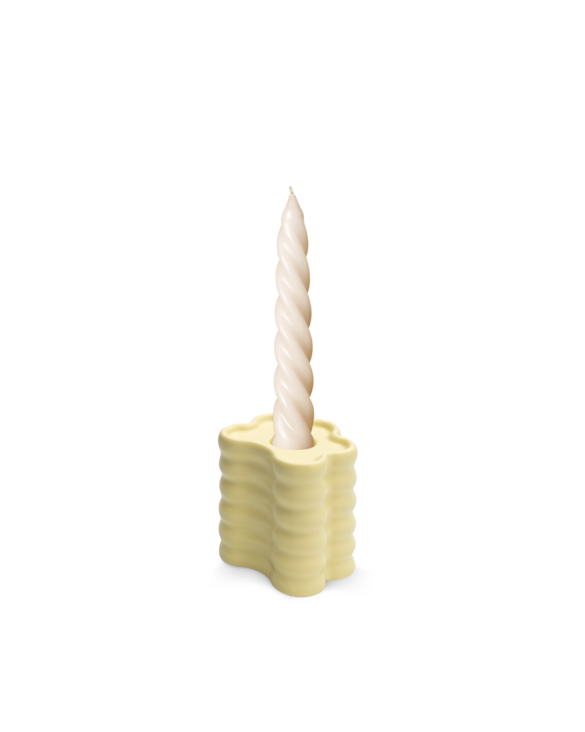 A twisted white candle sits in an OCTAEVO Flora Candle Holder in Yellow, its wavy ceramic design shown on a plain white background.