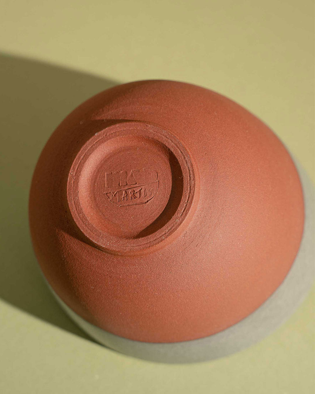 Beveled red stoneware cup